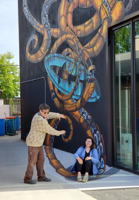 If this were a real Kraken, artist Holly Fields-Scott and her daughter Nevada Scott wouldn’t be so happy to show off the 3D arm coming out at them.